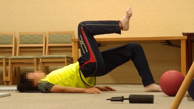 実業団の練習で、ランニングの合間に横になって補強運動とレストを行っている様子